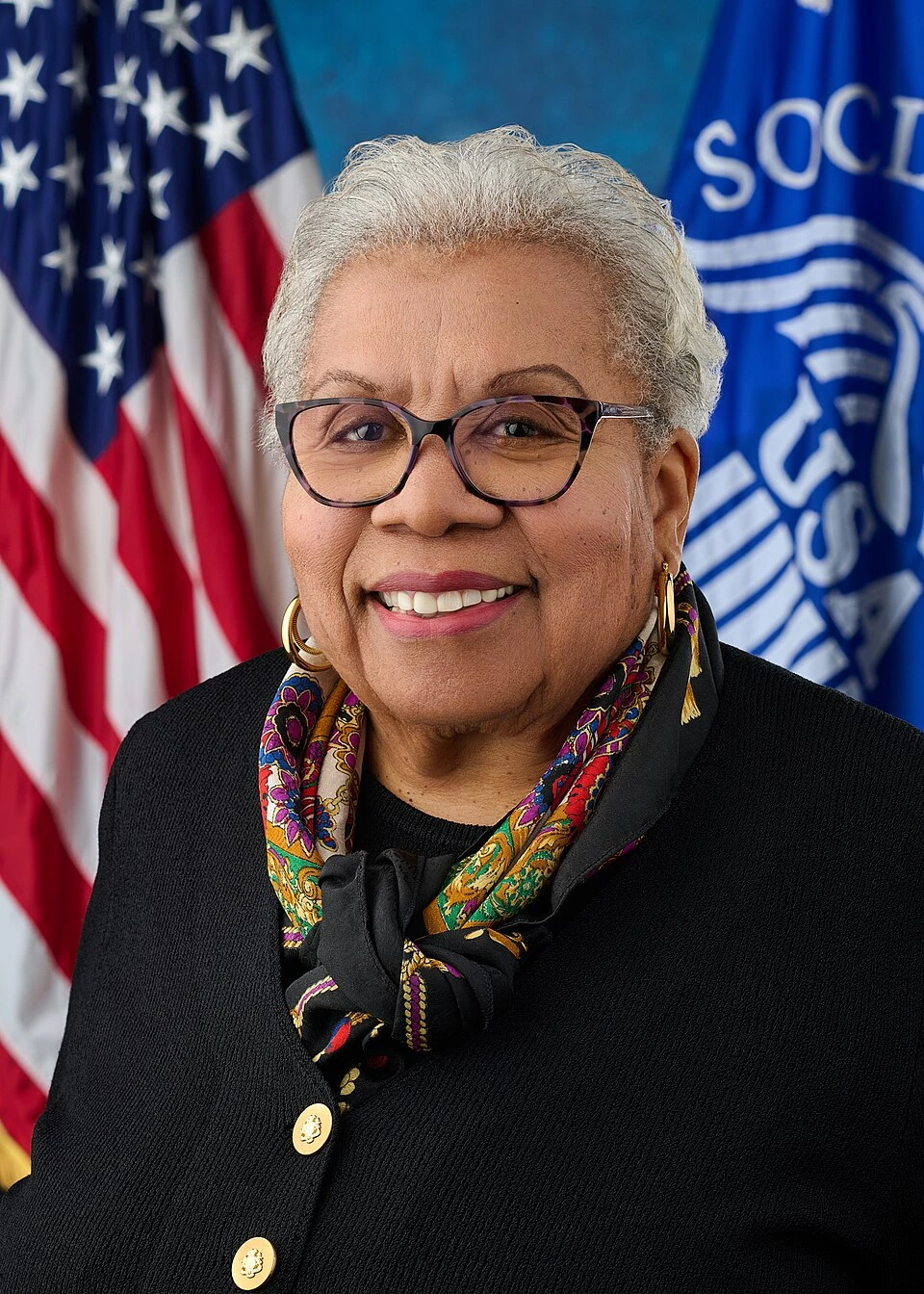 Portrait of Michelle King in front of the U.S. flag and Social Security Administration backdrop