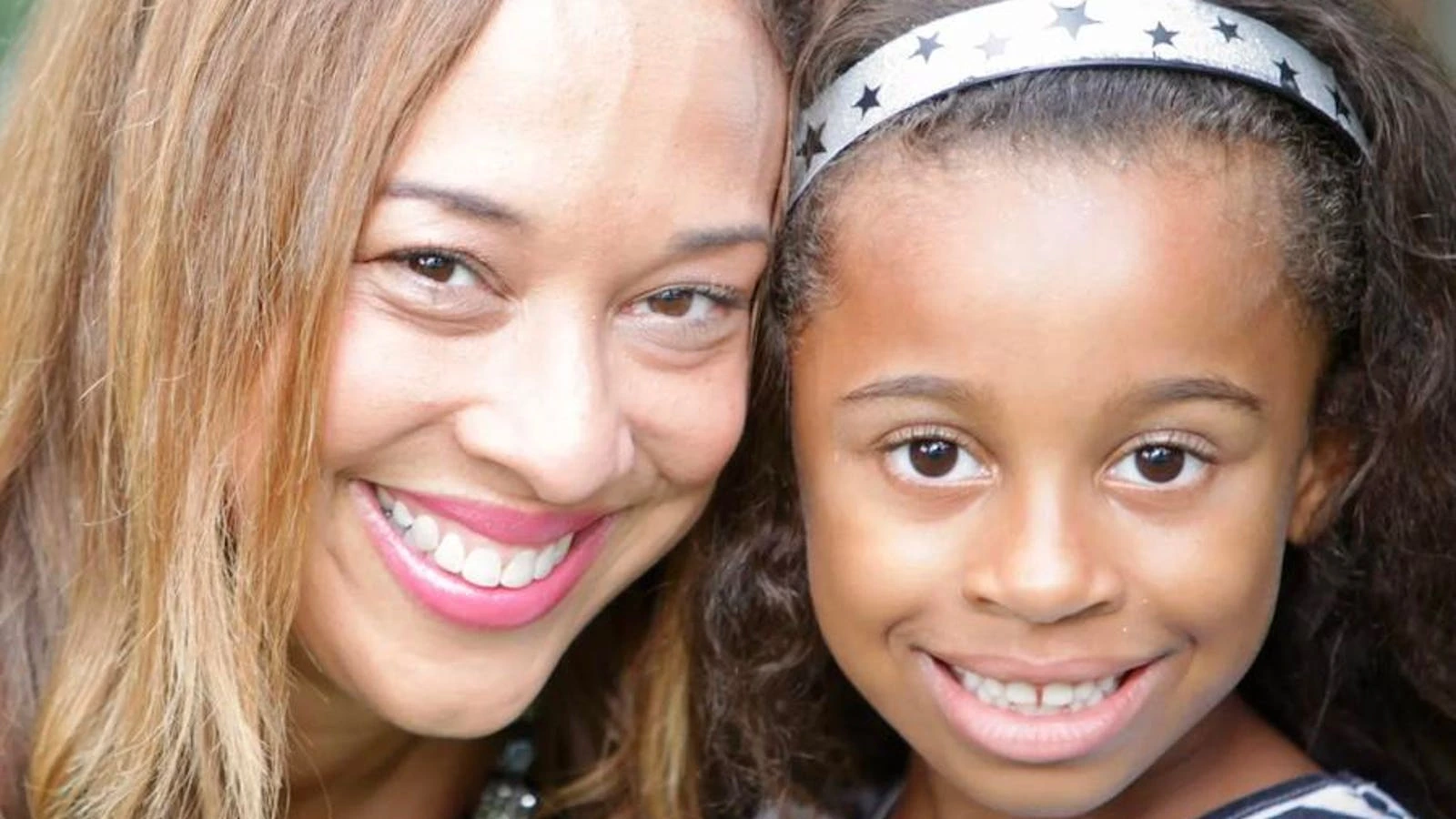 Michelle Hord smiling with a child in a close-up photo